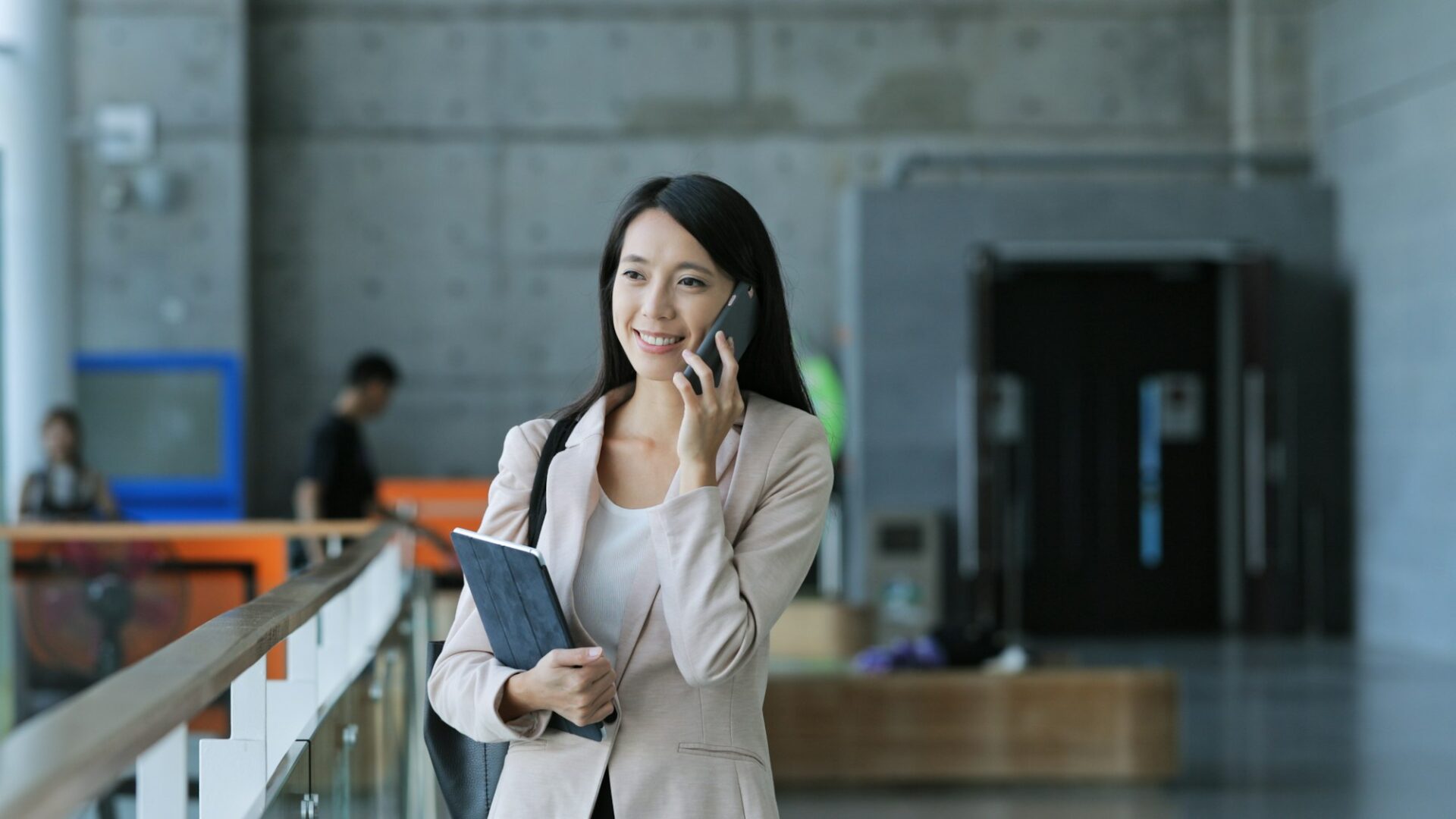 Business woman holding tablet computer and talk to mobile phone